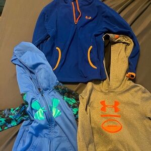3 Under Armour sweatshirts. One hoodie, one hoodie zip up, one quarter zip.